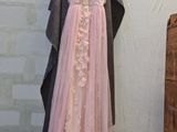 a dress hanging on a clothes rack in the corner of a room
