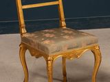 a chair that is sitting on the floor in front of a blue wall