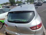 a silver car that is parked on the side of the road