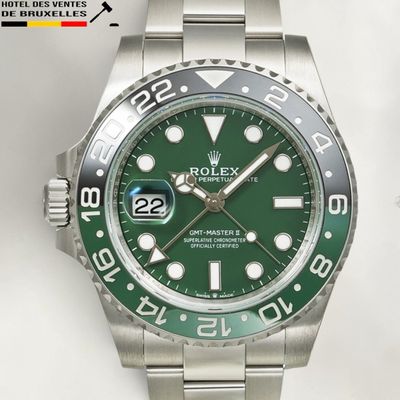 a rolex watch with a green dial on a bracelet