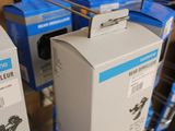 several boxes are stacked on a wire rack in a store