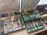 a refrigerator filled with silverware and silver spoons