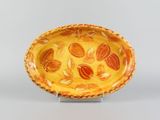 a yellow bowl with almonds on it on a stand