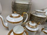a lot of white and gold china on the table