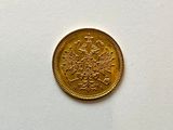 a gold coin sitting on top of a white table