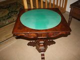 a wooden table with a green cloth on top of it