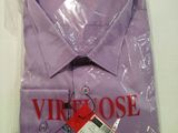 a purple shirt wrapped in plastic on a white table