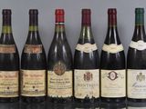 several bottles of wine are lined up on a table