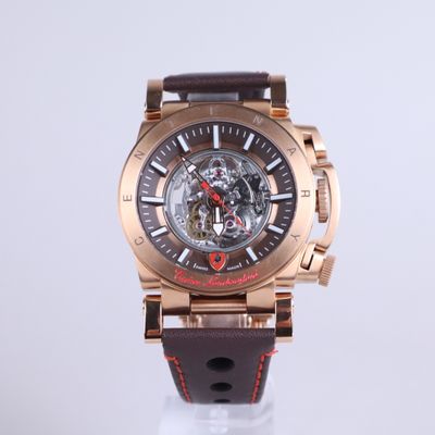 a close up of a watch with a brown strap