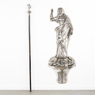 a statue of a woman holding a glass and a cane