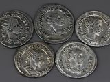 four silver coins with a picture of a man and a woman on them