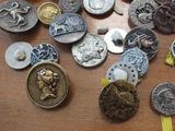 many different types of buttons on a table