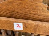 a wooden chair that has a sticker on the back of it