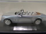 a model of a silver car on display in a glass case