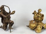 pair of antique bronze figurines of a man and a woman