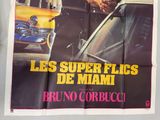 movie poster of a man leaning on a car in front of a yellow car