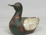 an image of a duck with a shell in its beak