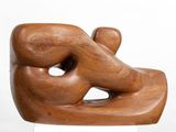 wooden sculpture of a man and a woman holding each other ' s hands
