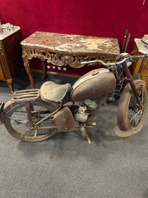 an old motorcycle that is sitting in a room