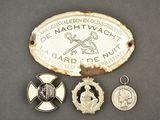 three medals and a medal are sitting on a table