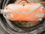 a close up of an orange and black hose on a floor