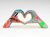 two hands making a heart with graffiti paint on them