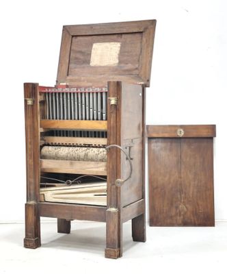 an old wooden cabinet with a book on top of it