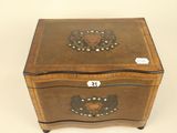 an old wooden box with a heart on the lid