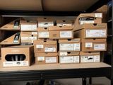 many boxes of electronic devices on a shelf in a room