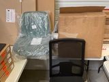 a black office chair sitting in front of a stack of boxes