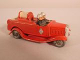 a red toy fire truck with a man in it