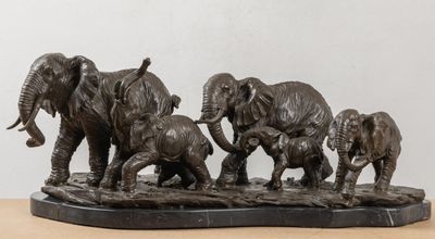 a statue of a family of elephants on a table