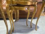 three tables that are sitting on the floor in a room