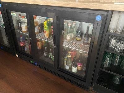 many bottles of alcohol on the shelves in the bar