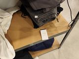 a pile of clothes sitting on a shelf in a room