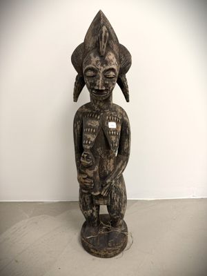 an image of a statue of a woman holding a baby