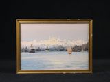 tableau encadré représentant une vue de ville avec des bateaux sur l'eau