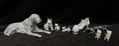 a group of figurines of dogs and cats on a black background