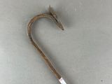 a close up of a metal stick with a hook on top of it