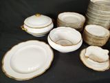 a lot of plates and bowls that are on a table