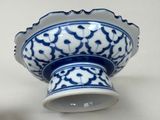 a blue and white bowl with a flower design on it