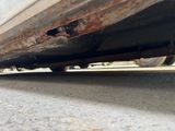 a close up of a car ' s exhaust pipe on the ground