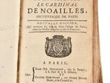 an open book with a picture of a coat of arms on top of it