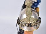 a helmet with a red, white, and blue feather on it