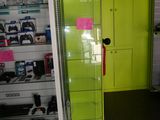a green refrigerator in a store with a sign on it
