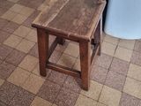 a small wooden table with a green box on top of it
