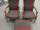 two chairs and a foot stool in a room