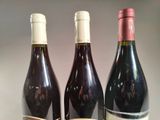 three bottles of wine sitting next to each other on a table