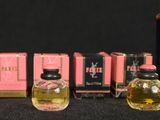 several bottles of perfume sitting next to each other on a table