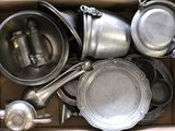 a cardboard box filled with many different types of pots and pans